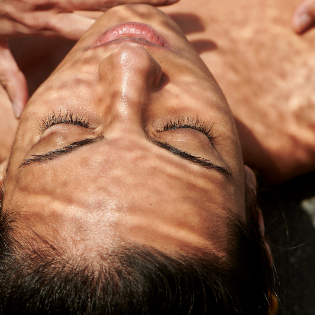 Close up of Woman lying down with water ripple reflections on her face — peaceful skincare moment for Mythic Cosmetics email sign-up.